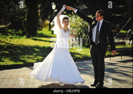 Dancing wedding couple outdoors Stock Photo