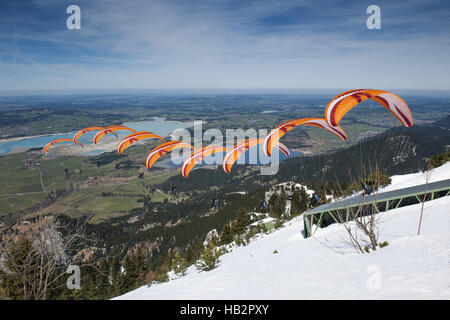Paraglider sequence orange in Bavaria Stock Photo