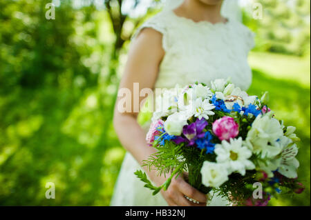 Wedding bouquet on hand of bride Stock Photo