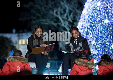 U.S First Lady Michelle Obama and Olympic Gold Medalist Simone Manuel read ''Twas the Night Before Christmas' during the national Christmas tree lighting ceremony on the Ellipse December 1, 2016 in Washington, DC. Stock Photo