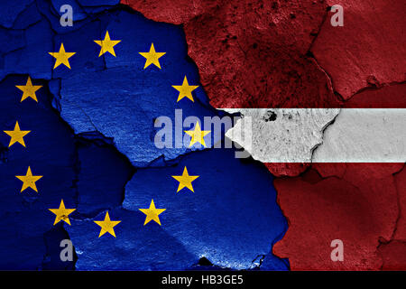 flags of EU and Latvia painted on cracked wall Stock Photo