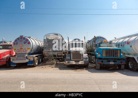 Big fuel gas tanker trucks parked on highway Stock Photo