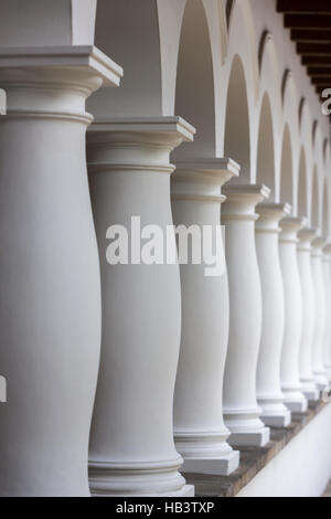 Colonial architectural details in Quito, white columns aligned in a row Stock Photo