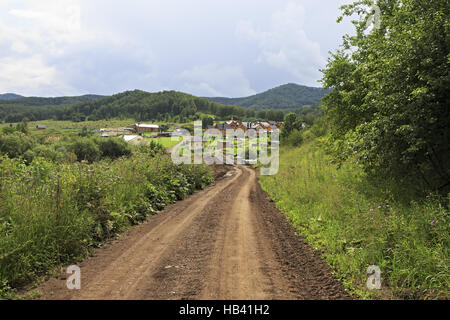 Dirt road to new village in Altai. Stock Photo