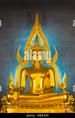 Illuminated golden Buddha inside a Thai temple, Bangkok, Thailand. Stock Photo