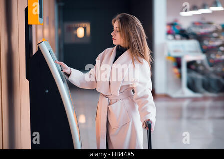Young woman at self service transfer area. Stock Photo