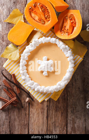 Tasty pumpkin cheesecake with whipped cream close-up on the table. vertical view from above Stock Photo