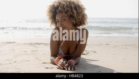 Woman In A Swimsuit Relaxing On The Sand Stock Photo