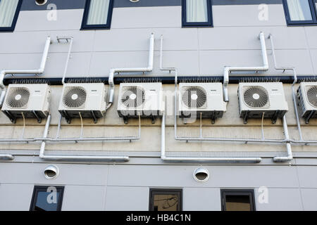 Air conditioners on the outside of a building in Japan. Stock Photo