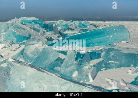 Clumps of blue ice on the snow. Stock Photo