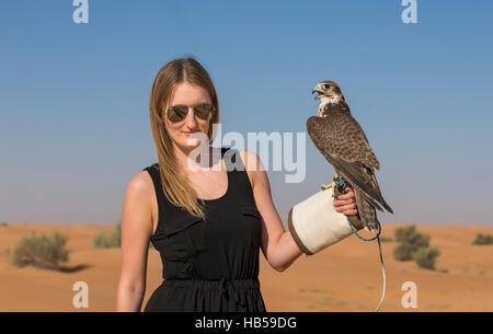 Young woman with Saker falcon (falco churrug) Stock Photo