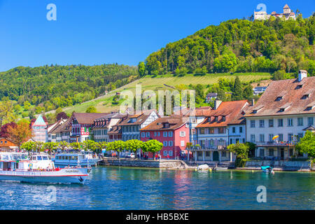 Excursion boat on Rhein river with castle in old city center of Stein am Rhein village with colorful old houses Stock Photo