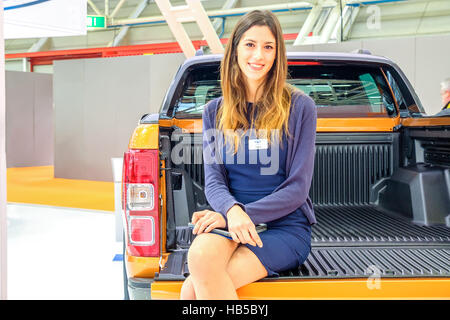 Bologna, Italy, Dec 03 2016 - a model sit in the back of an orange  Ford Ranger Wildtruck pickup during the Motorshow 2016 in Bologna Stock Photo