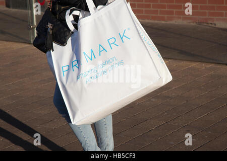 Shoppers with Primark reusable bags of store purchases at Houndshill Shopping Centre, Bank Hey St, Blackpool Lancashire, UK Stock Photo