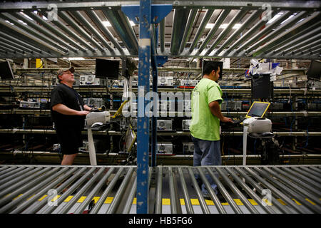 A workers check old hard drives at Tech Turn, a computer recycling company. Stock Photo