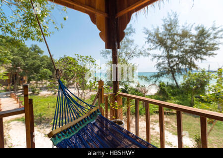 Hammock and bungalows on tropical beach Koh Rong Island, Cambodia Stock Photo