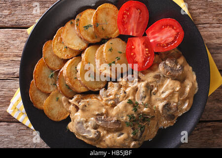 Diana steak with mushrooms and cream sauce close-up on a plate. horizontal view from above Stock Photo
