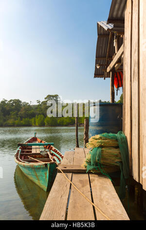 Fisher boat near by wooden house on Ko Rong Island, Cambodia Stock Photo
