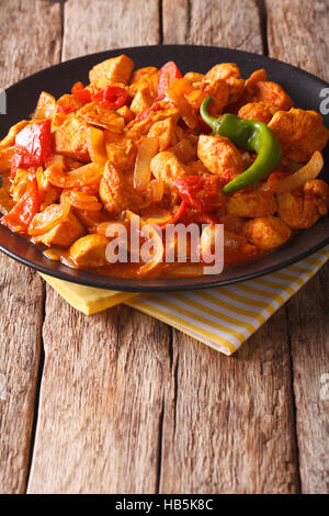 Chicken jalfrezi Indian culture fried spicy curry chilli sauce meat and vegetables healthy dietetic food. Vertical Stock Photo