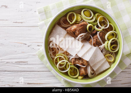 Korean cuisine: Galbitang soup with beef ribs, rice noodles and daikon close up in a bowl. horizontal view from above Stock Photo