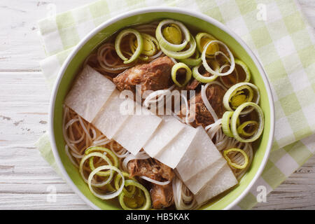 Galbitang Korean soup with beef ribs, rice noodles and daikon close up in a bowl. horizontal view from above Stock Photo