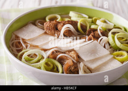 Galbitang Korean soup with beef ribs, rice noodles and daikon close up in a bowl. horizontal Stock Photo