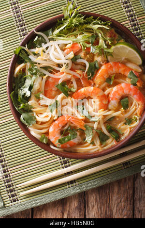 Malaysian laksa soup with prawns close up in a bowl on the table. vertical view from above Stock Photo