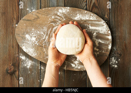Female hands kneading dough Stock Photo