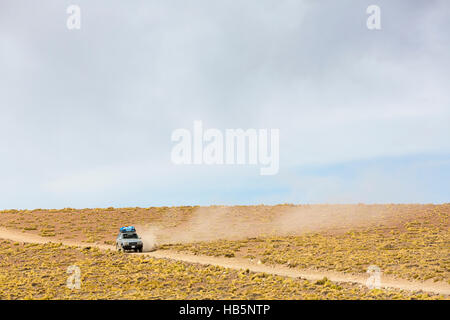 Off-road vehicle driving in the Atacama desert, Bolivia Stock Photo