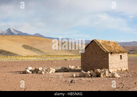Adobe house on Bolivian Altiplano with Andean mountain, Bolivia Stock Photo