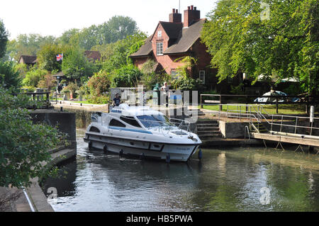 Berkshire - Sonning Lock - river Thames - pleasure cruiser leaving the lock - sunlight and shadows - reflections - cottage Stock Photo