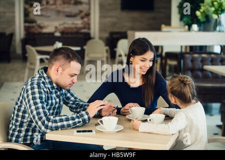 Family Enjoying tea In Cafe Together Stock Photo