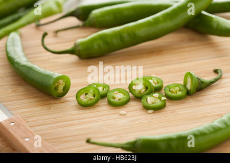 Green hot chili peppers, slices and seeds Stock Photo