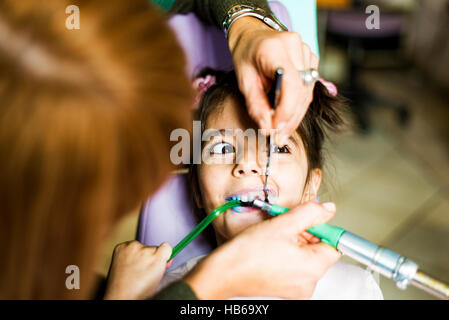 Little girl getting dental treatment in dentist office Stock Photo