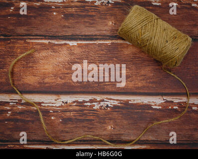 Rough thread reel on wood background Stock Photo