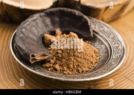 carob pods and carob powder Stock Photo