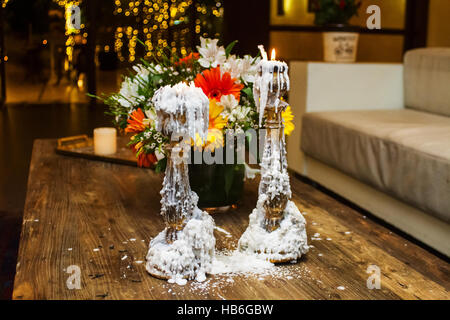 Photo of old candles and flowers . Stock Photo