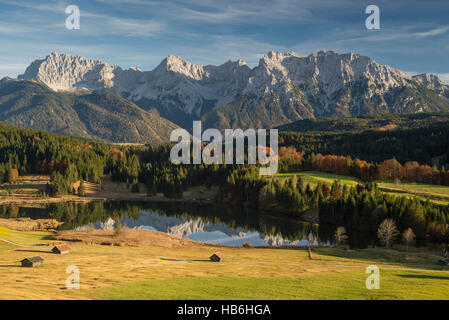 Lake Gerold and the Karwendel mountains surrounded by colorful meadows and bright autumn forest, Bavaria, Germany Stock Photo