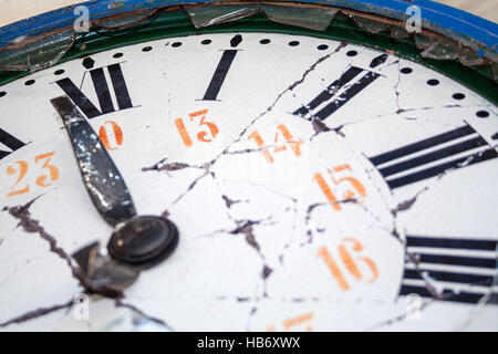 Close up detail of an old damaged retro clock, with broken face, hands and glass, and with roman numerals Stock Photo