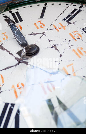 Close up detail of an old damaged retro clock, with broken face, hands and glass, and with roman numerals Stock Photo