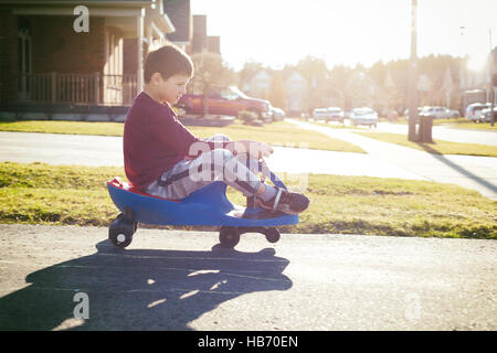 boy riding scooter Stock Photo