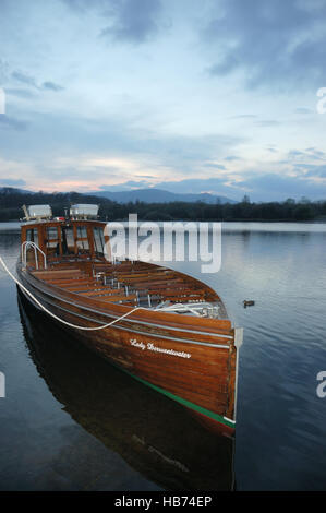 The launch Lady Derwentwater a passenger vessel operating on Derwentwater at Keswick in the English Lake District moored at dusk Stock Photo