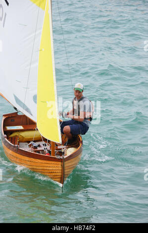 Young man in a Sea View One-Design (SVOD) Dinghy class boat on The Solent at Seaview on the Isle of Wight Stock Photo