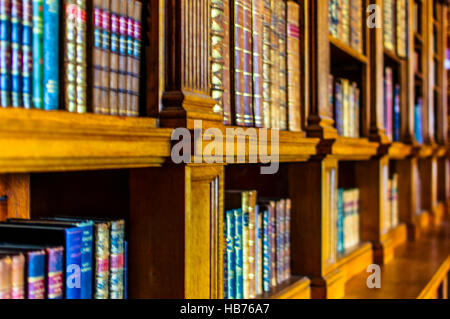 old bookcase with bound books Stock Photo