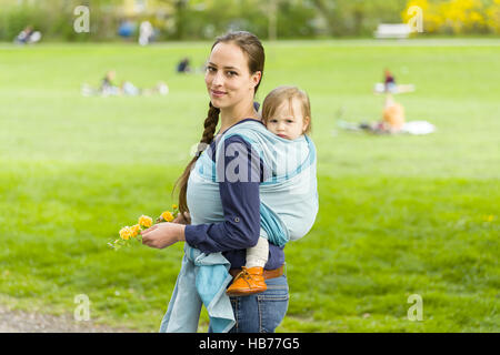 mother and child in baby sling Stock Photo