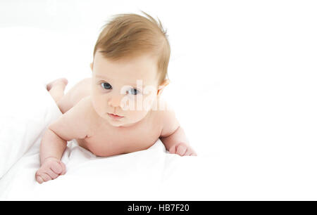 cute baby lying on her belly on a white background Stock Photo