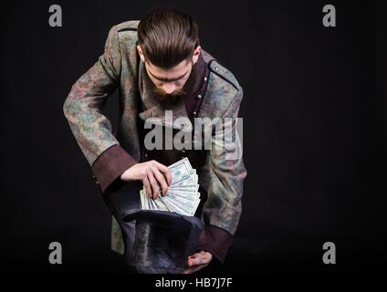 Wizard man making money with witchcraft. Stock Photo