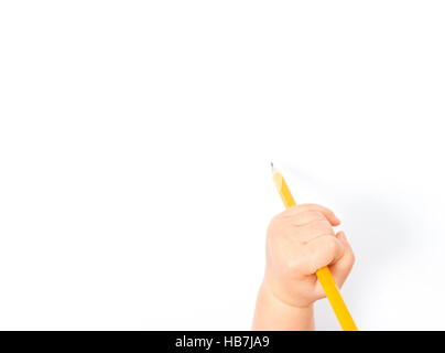 a baby's hand prepared for drawing on a white sheet of paper Stock Photo