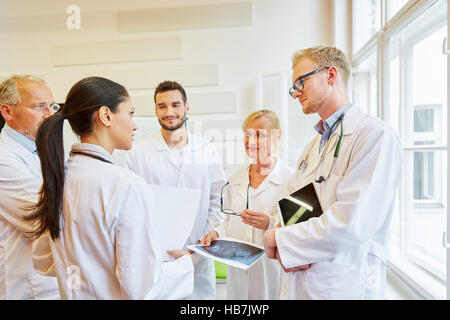 Team of doctors in discussion about patient situation Stock Photo