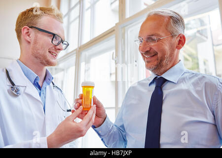 Senior patient receives drug from doctor for therapy treatment Stock Photo